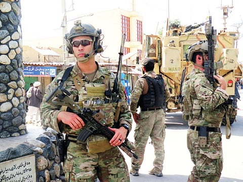 U.S troops keep watch during an official visit in Farah province, Afghanistan