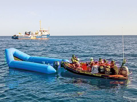 File photo: A Sea-Watch ship approaches a dinghy to rescue migrants in the Mediterranean Sea