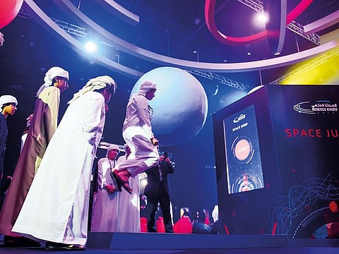 Students try the Space Jump, which compares gravity on the Moon, Mars and Jupiter, at the MBRSC’s Science event in Dubai.
