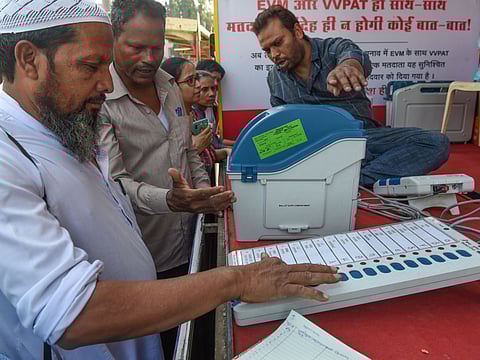 In this file photo taken on January 16, 2019, Indians try out the Electronic Voting Machine (EVM) in conjunction with the Voter-Verified Paper Audit Trail (VVPAT), a ballotless voting system, at an Election Commission demonstration stand in Mumbai.