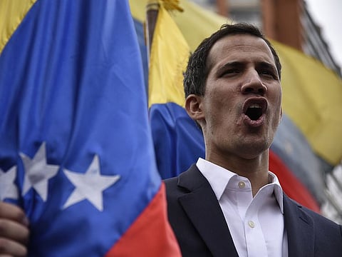 Juan Guaido, president of the National Assembly, sings the national anthem during a pro-opposition rally in Caracas, Venezuela, on Wednesday, Jan. 23, 2019.