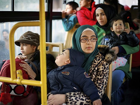 Syrian refugees sit in a bus waiting to take them home to Syria, in the northern Beirut suburb of Burj Hammoud, Lebanon, on Thursday, January 24, 2019.