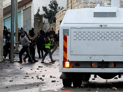 Palestinian youth clash with Israeli soldiers in the West Bank village of Tuqua, south-east of Bethlehem on January 18, 2019.