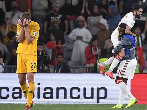 Australia's midfielder Jackson Irvine, left, holds his head after losing 1-0 to United Arab Emirates during the AFC Asian Cup quarterfinal soccer match at Hazza Bin Zayed Stadium in Al Ain, United Arab Emirate