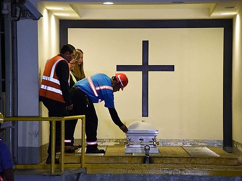 Funeral home employees prepare the coffin, containing the repatriated body of eight-year-old migrant Felipe Gomez, before driving his remains to Yalambojoch village, Nenton municipality, Huehuetenango department, 400 km northwest Guatemala City on January 25, 2019.