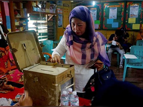 A woman casts her vote during the plebiscite on Bangsamoro Organic Law at a voting precinct in Sultan Kudarat, Maguindanao provinces, Philippines on January 21, 2019.
