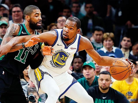 Golden State Warriors forward Kevin Durant (35) works against Boston Celtics guard Kyrie Irving (11) during the second half of a 115-111 victory by Golden State at TD Garden
