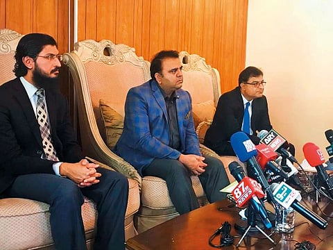 Minister of Information Fawad Chaudhry (centre)