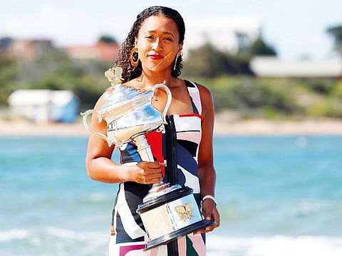 Osaka poses with her trophy after winning the Australian Open on Saturday.