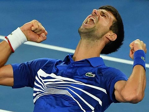 Serbia's Novak Djokovic celebrates his victory against Spain's Rafael Nadal during the men's singles final on day 14 of the Australian Open tennis tournament in Melbourne on January 27, 2019.