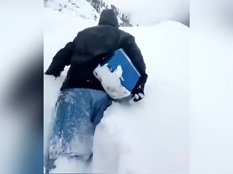 WATCH: Pakistani polio worker walks through waist-high snow