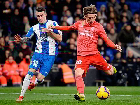 Real Madrid's Croatian midfielder Luka Modric (R) challenges Espanyol's Spanish midfielder Alex Lopez during the Spanish league football match at the RCDE Stadium in Cornella de Llobregat on January 27, 2019.