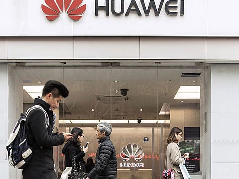 File photo: Pedestrians walk past a Huawei Technologies Co. store in Shanghai, China.