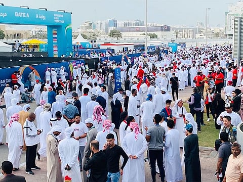 Football fans gather outside the Mohammad Bin Zayed stadium.