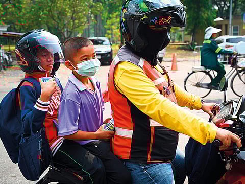Children leave school early due to pollution in Bangkok yesterday. Toxic smog forced authorities to issue an order to shut nearly 450 schools in the city.