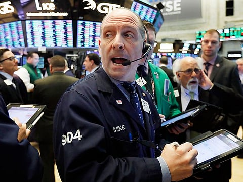 Traders work on the floor of the New York Stock Exchange.