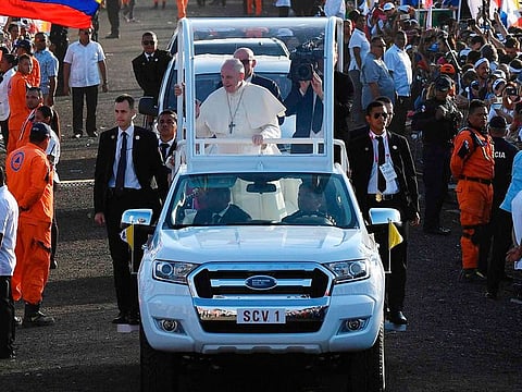 Pope Francis waves to pilgrims as he arrives in the popemobile to give an open-air mass at the Campo San Juan Pablo II on the outskirts of Panama City, on January 27, 2019.