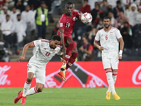 Qatar's forward Almoez Ali jumps for the ball by UAE's midfielder Khamis Ismail during the AFC Asian Cup semifinal soccer match held at Mohammed Bin Zayed Stadium in Abu Dhabi, on Tuesday, January 29, 2019.