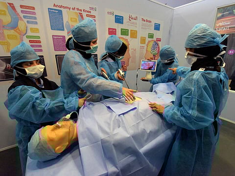 Sixth graders from Al Zallaqa School in Bani Yas perform ‘gall stone surgery’ on a mannequin at the Abu Dhabi Science Festival, which got under way at the Corniche on Thursday.