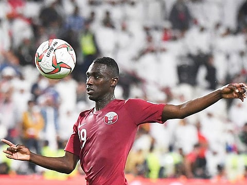 Qatar's forward Almoez Ali eyesthe ball during the AFC Asian Cup semi-final against the UAE at Mohammad Bin Zayed Stadium in Abu Dhabi, on Tuesday, January 29, 2019.