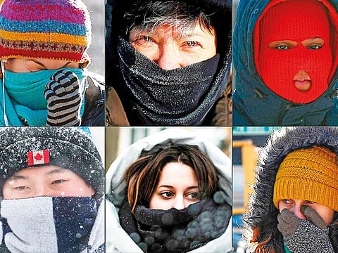 This combination of pictures shows pedestrians protecting their faces from the cold in New York City; in Washington DC; along Lake Michigan’s ice covered shoreline; in Brooklyn, New York; in Chicago; in Kingston, Ontario, and Montreal.