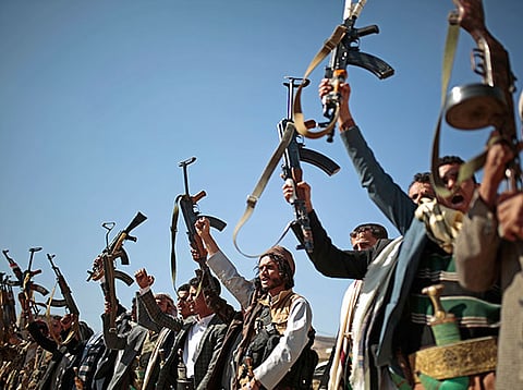Tribesmen loyal to Al Houthi rebels hold up their weapons as they attend a gathering to show their support for the ongoing peace talks in Sanaa, Yemen. File photo taken on December 13, 2018.