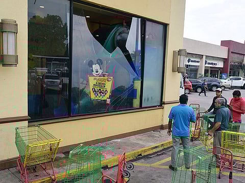 People stand near a broken glass from a restaurant after an earthquake in Tapachula, in Chiapas state, Mexico February 1, 2019.