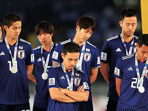 Japan players look dejected after losing the Asian Cup final against Qatar at the Zayed Sports City Stadium in Abu Dhabi on Friday. Qatar won 3-1.