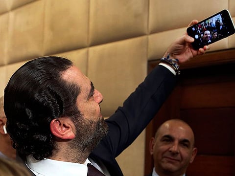Lebanese Prime Minister Sa’ad Hariri, takes a selfie with reporters after he announced his new cabinet, at the presidential palace in Baabda.