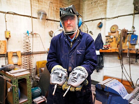 Patrick Helly, owner of New Pro Foundries, with a freshly cast Bafta mask.
