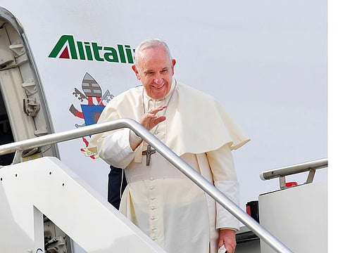 Pope Francis waves as he boards a plane at Fiumicino airport on his way to a three-day visit to the UAE. His visit is taking place early in the Year of Tolerance.