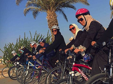 A group of young women cyclists ready to whizz on the newly built cycling track near the seaside.