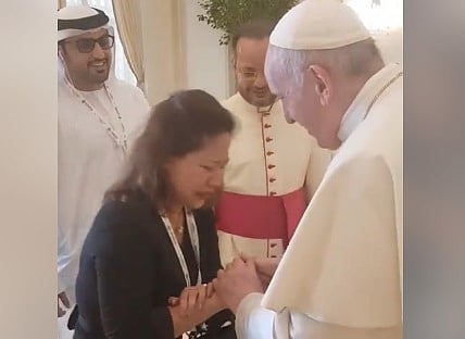 Filipina migrant worker Sally Mallari, a widow for 13 years, sobs during a brief encounter with Pope Francis in Abu Dhabi.