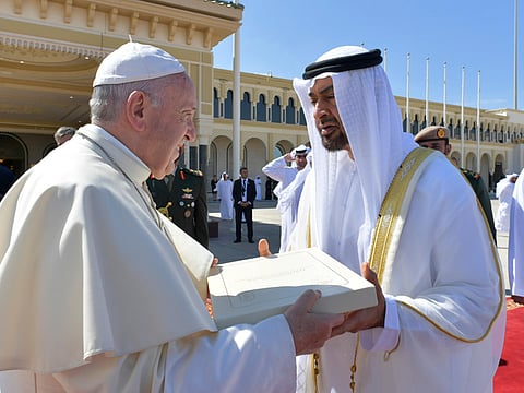 This handout photo released by the Vatican Media, shows Pope Francis (L) gifting Abu Dhabi's Crown Prince Mohamed Bin Zayed Al-Nahyan a copy of the Human Fraternity document ahead of boarding his plane on February 5, 2019. - RESTRICTED TO EDITORIAL USE - MANDATORY CREDIT "AFP PHOTO / VATICAN MEDIA"