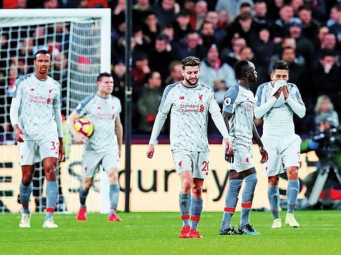 Liverpool players react after conceding their first goal against West Ham in their Premier League clash on Monday.