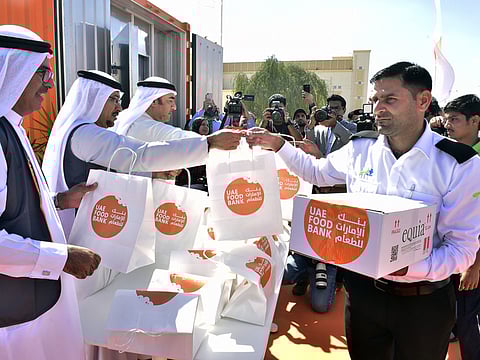 Archive photo of workers receiving parcels at a UAE Food Bank facility in Dubai