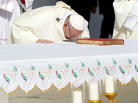 Pope Francis bows on the altar as he celebrates a mass at the Zayed Sports City Stadium in Abu Dhabi.