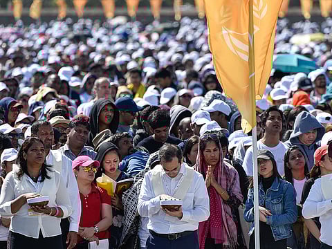 Worshippers pray during a mass service led by Pope Francis, at the Zayed Sports City Stadium in Abu Dhabi.