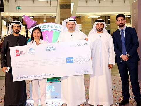 Angela Mortos, a Dubai-based nurse from the Philippines, receives Dh100,000 as part of the DSF campaign.