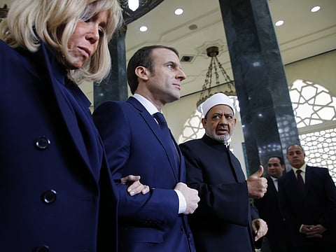 French president Emmanuel Macron and his wife First Lady Brigitte Macron are accompanied by Shaik Ahmed Al Tayyeb, the head of Al Azhar, the Sunni Muslim world's premier Islamic institution, right, during his visit to Al Azhar headquarters, in Cairo, Egypt, on Tuesday, January 29, 2019.