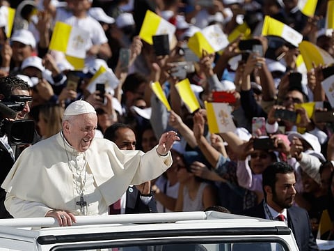 Pope Francis greets the crowd as he arrives to lead mass at the Zayed Sports City Stadium, Abu Dhabi.