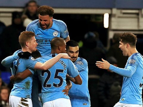 Manchester City's Gabriel Jesus, obscured, celebrates with teammates after scoring his side's second goal of the game against Everton.