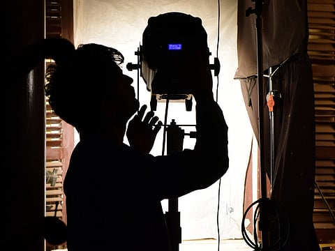 A lightman adjusts the spotlight during a shooting of Sony SAB TV's new serial ‘Beechwale – Bapu Dekh Raha Hai’ at the Filmcity in Goregaon.