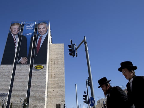 A giant election billboard of Israeli Prime Minister Benjamin Netanyahu and US President Donald Trump shaking hands. The writing on the Tel Aviv billboard reads in Hebrew “Netanyahu, in another league”.