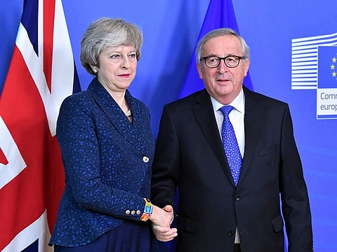 European Commission President Jean-Claude Juncker shakes hands with British Prime Minister Theresa May.