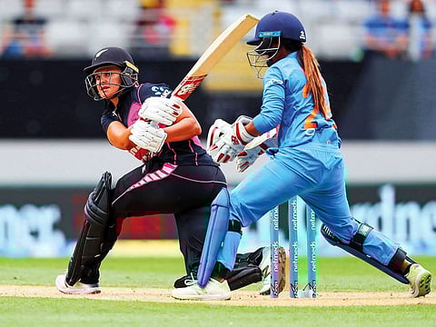 New Zealand's Suzie Bates (L) playes a shot beside India's Taniya Bhatia during the second Twenty20 international women's cricket match between New Zealand and India in Auckland on February 8, 2019.