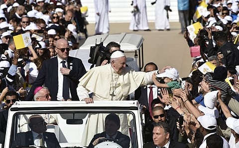 Pope Francis blesses baby at mass