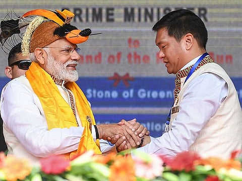 Modi (left) shakes hands with Arunachal Pradesh CM Pema Khandu at the inauguration of several development projects, in Itanagar