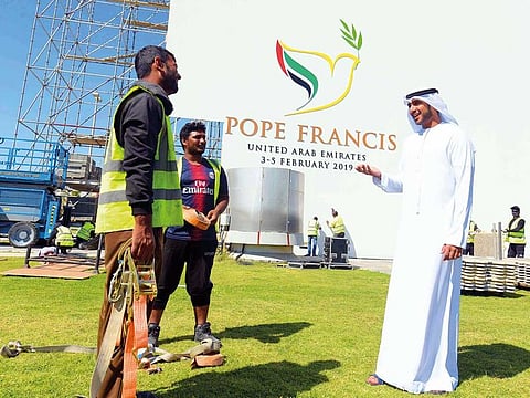 Murshid Al Rumaithy gives instructions to workers at Zayed Sports City, Abu Dhabi yesterday. He is supervising the dismantling of installations at the venue of papal mass.