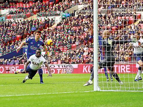 Tottenham Hotspur's Colombian defender Davinson Sanchez (2L) dives to score the opening goal during the English Premier League football match between Tottenham Hotspur and Leicester City at Wembley Stadium in London.